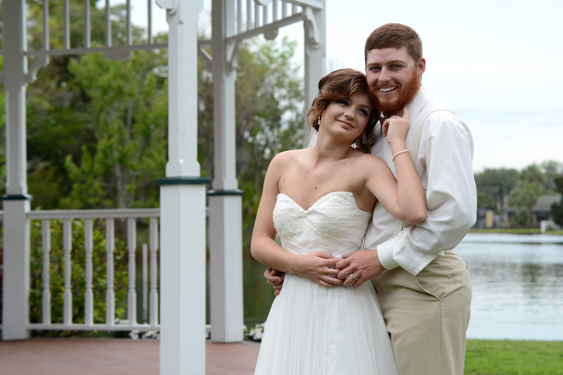Bride and groom pose for their first photo as husband and wife at their beautiful wedding venue